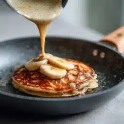 Banana pancake protein recipe that delivers 40g of blissful energy in every bite 4 Close-up of stacked banana protein pancakes with toppings