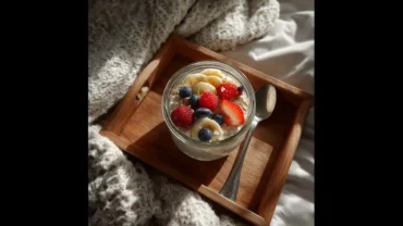 Healthy overnight oats breakfast with fruit topping on a cozy tray