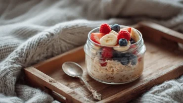 Healthy overnight oats breakfast with fruit topping on a cozy tray